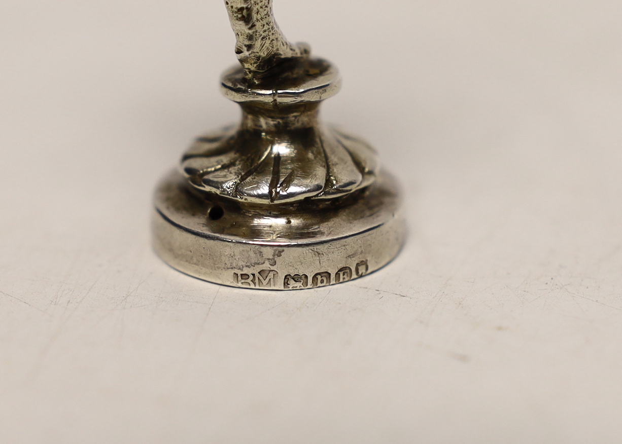A late Victorian silver miniature model of a Falconer, on a circular base, import marks for Berthold Muller, London, 1897, 9cm.
